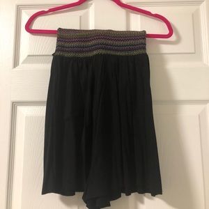 Black strapless striped romper.